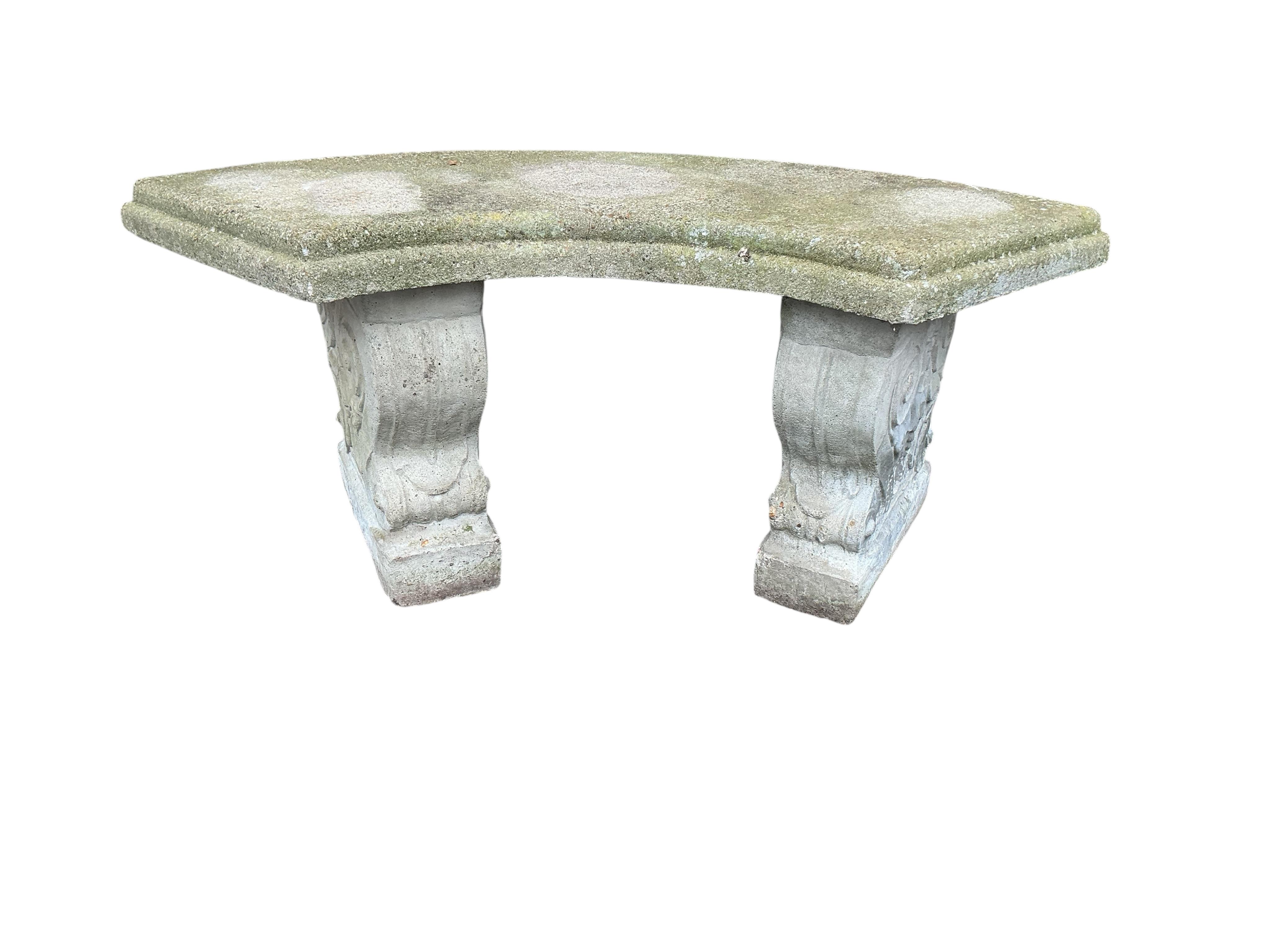 A reconstituted stone curved garden bench, width 106cm, height 44cm